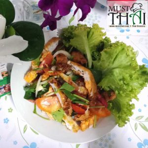 Spicy salad with fried eggs